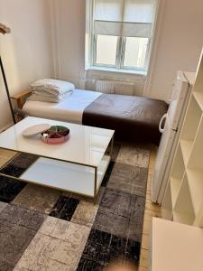 a small bedroom with a bed and a table at Nordhavn Cozy Room in shared apartment in Copenhagen