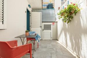a small alley with a table and chairs and a building at Monolocale Marizzola in Cala Gonone +23 photos