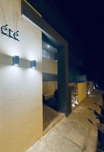 a building with lights on the side of it at night at été 1 in Kardamaina