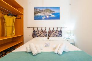 a bedroom with a bed with towels on it at Monolocale Marizzola in Cala Gonone