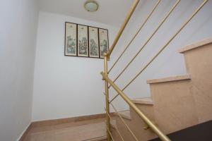 a staircase in a building with a clock on the wall at Apartments Ankora in Tučepi