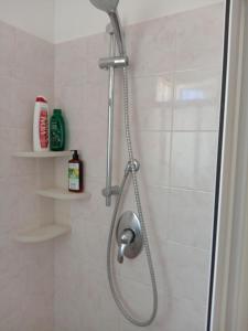 a shower with a shower head in a bathroom at Camera matrimoniale con bagno in Castellana Grotte