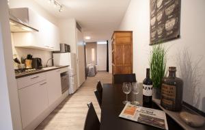 a kitchen with a table with wine bottles and glasses at Apartment 4G in Amersfoort