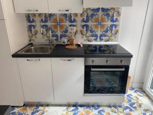a small kitchen with a sink and a stove at Casa di Eleonora in Ventotene
