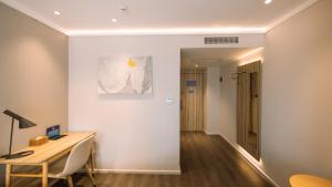 a room with a desk and a table and a hallway at Hanting Premium Beijing Wudaokou Tsinghua East Gate Hotel in Beijing