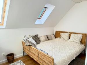 a bedroom with a wicker couch in a attic at Lake Balaton Panorama Mansion in Révfülöp