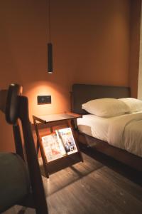 a hotel room with a bed and a table with a magazine at Carnarvon 73 in George Town