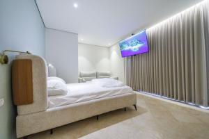 Ένα ή περισσότερα κρεβάτια σε δωμάτιο στο Shani house of style shunit penthouse +45 φωτογραφίες