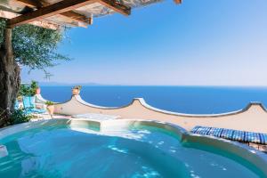 a swimming pool in a villa with a view of the ocean at Smeraldo Holiday House in Conca dei Marini