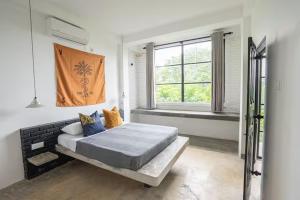 a bedroom with a large bed and a window at REZ SPACE Apartment 03 in Dickwella