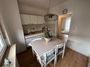 a kitchen and dining room with a table and chairs at Fewo Dragidella in Lollar