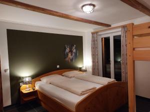 une chambre avec un grand lit avec des draps blancs dans l'établissement Ferienwohnung Aineck in Sankt Michael im Lungau, à Sankt Michael im Lungau 9 autres photos
