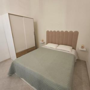 a bedroom with a large bed and a mirror at Casa Olivia in Castellammare del Golfo +4 photos