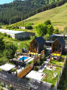 an aerial view of a property with a pool and houses at White Scandinavian Barn House in Artavaz