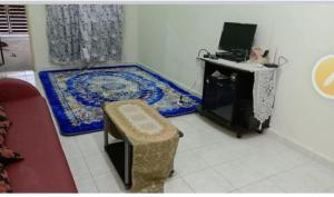 a room with a desk and a rug on the floor at Humairah Home Stay in Ranau