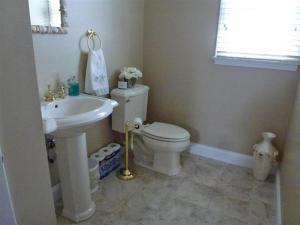 a bathroom with a white toilet and a sink at Oceanside Brant Beach Single Family Beach Badges Private Yard Wifi Ocean And Bay Views Washer & Dryer This Home Will Allow You To Truly Feel in Brant Beach +24 photos