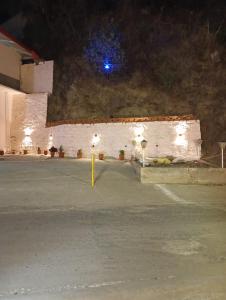 an empty parking lot at night with a blue light at Royal hills kasauli home stay in Kasauli