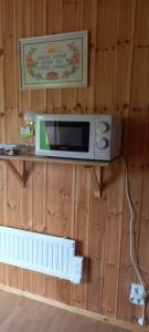 a microwave on the wall of a room at Mysan in Glommersträsk +23 photos