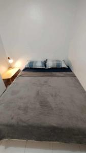 a large bed in a room with a bed sidx sidx sidx at Charming home with lush garden in Buhangin Davao City in Davao City