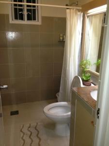 a bathroom with a toilet and a sink at Charming home with lush garden in Buhangin Davao City in Davao City