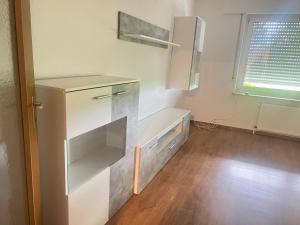 a kitchen with a white cabinet and a window at Red Dot Apartment Otto in Hamm