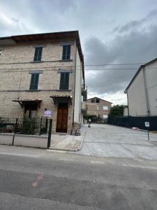 a brick building on the side of a street at IL PARADISO delle farfalle in Santa Maria degli Angeli