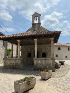 a large stone building with a clock tower on top at Rooms Poli Luce - Room Zvane in Gračišće +4 photos