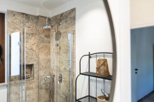 a bathroom with a shower with a glass door at Tenuta Poggio Piero in Montemassi +94 photos