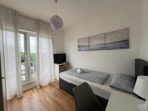 a small bedroom with a bed and a window at Hotel Breuer in Hamm