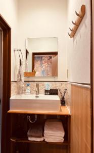 a bathroom with a sink and a mirror at 栄の宿 in Nara +28 photos