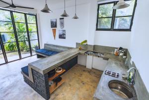 a kitchen with a sink in a room with windows at REZ SPACE Apartment 05 in Hiriketiya +8 photos