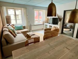 a living room with a couch and a table at Hygge Style Apartment in Steckborn
