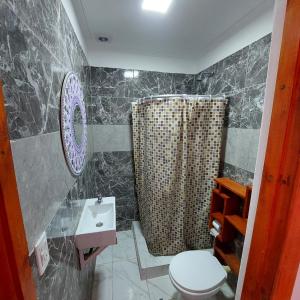 a bathroom with a shower and a toilet and a sink at MARRAKECH Apart-hotel in Camet Norte +39 photos