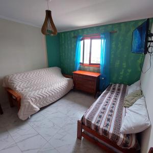 a small bedroom with two beds and a window at MARRAKECH Apart-hotel in Camet Norte