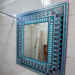 a mirror in a bathroom with blue and white tiles at MARRAKECH Apart-hotel in Camet Norte