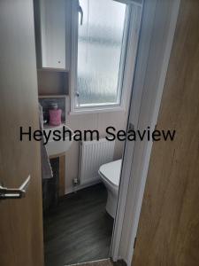 a bathroom with a toilet and a window at Heysham seaview in Heysham +35 photos