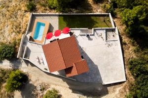 an overhead view of a house with a pool at Villa Nova in Podstrana