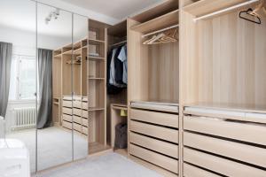 a walk in closet with wooden cabinets and a glass door at Omakotitalo Jyväskylän keskustassa in Jyväskylä
