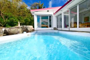 a swimming pool in the backyard of a house at Villa Lorizon in Rodrigues Island
