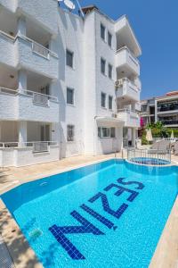 a swimming pool in front of a building at Sezin Apart in Marmaris