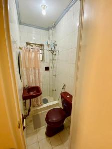 a small bathroom with a toilet and a sink at Cindys Get away in Ulot +41 photos