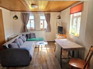 a living room with a couch and a table at FeWo altes Pfarrhaus in Erndtebrück