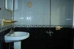 a bathroom with a sink and a toilet and a mirror at Ultimate Ballagio G-8 in Islamabad +27 photos