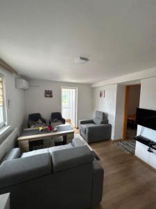 a living room with two couches and a table at Apartman Biser in Sarajevo