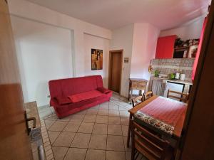 a living room with a red couch and a table at Apartmani Katja in Omiš