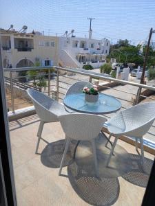 a patio with a table and chairs on a balcony at Niko's apartments 1 in Elafonisos