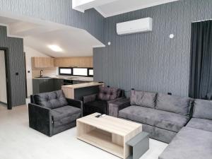 a living room with two couches and a table at гест хаус паркова 33 in Razgrad