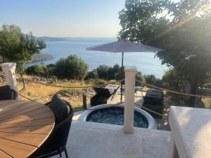 a patio with a table and an umbrella at Deja Blue Ustrine in Ustrine