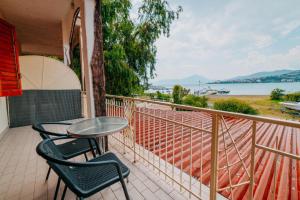 a balcony with a table and chairs and a view of the water at Hotel Da Attilio in Sapri