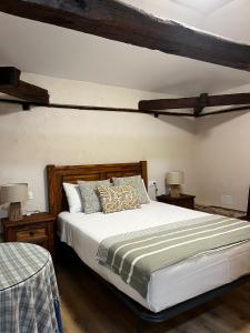 a bedroom with a large bed and two night stands at Apartametos rurales la Higuera de José in Layos